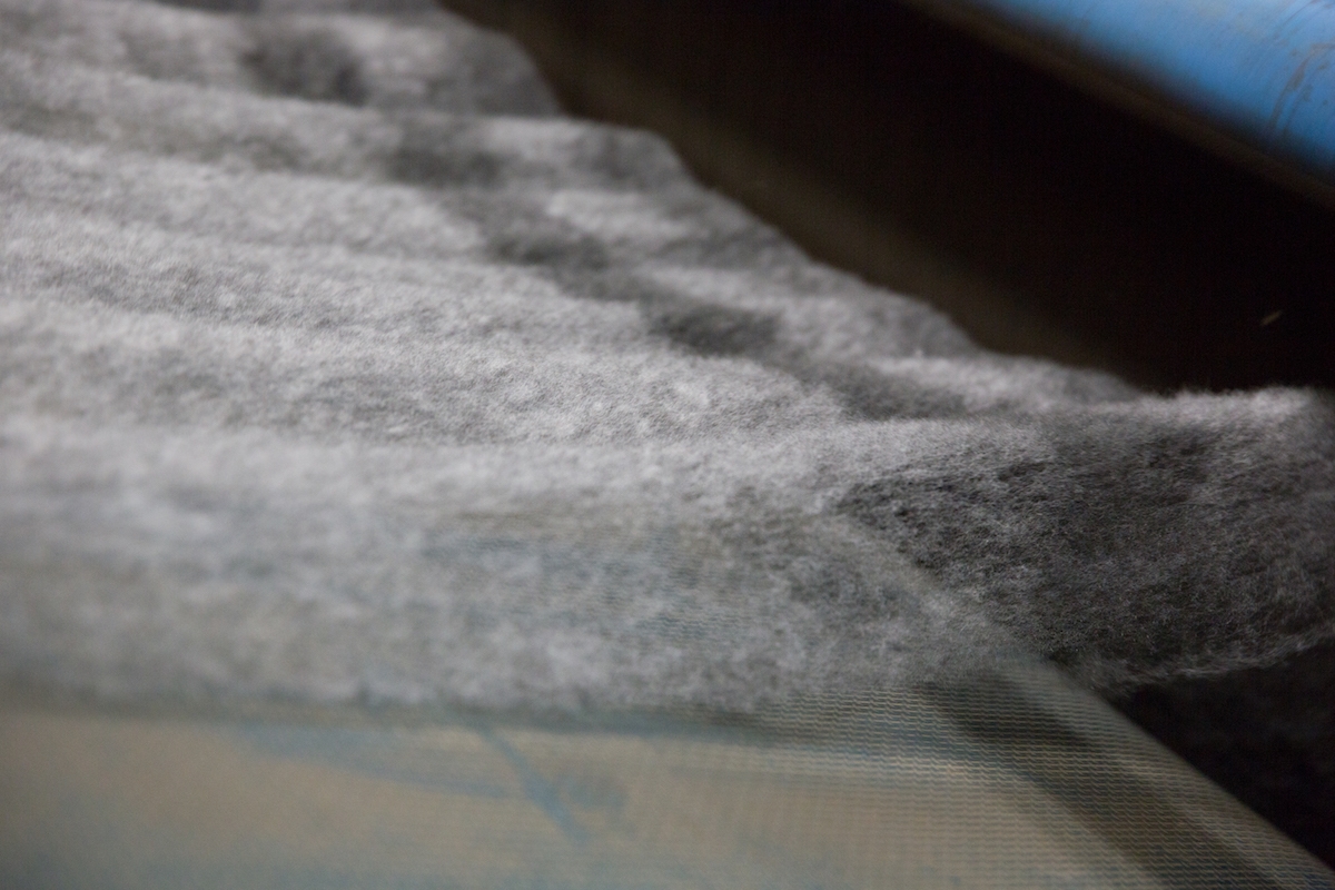 Recycled PET bottles (top) are carefully processed to form a spiderweb-like felt material (bottom) that is used for De Vorm's sustainable furniture designs.