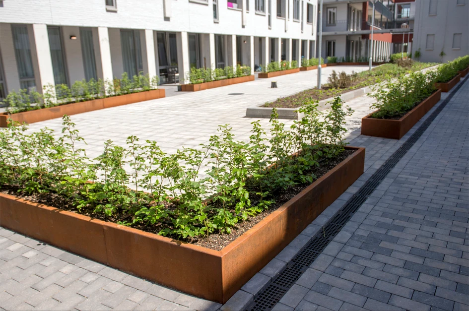 Corten steel planters in strong graphic designs make the link between the built and natural worlds; seen here at the Parc Fontaine residential development, Eindhoven (top) and Molenweg, Nijmegen