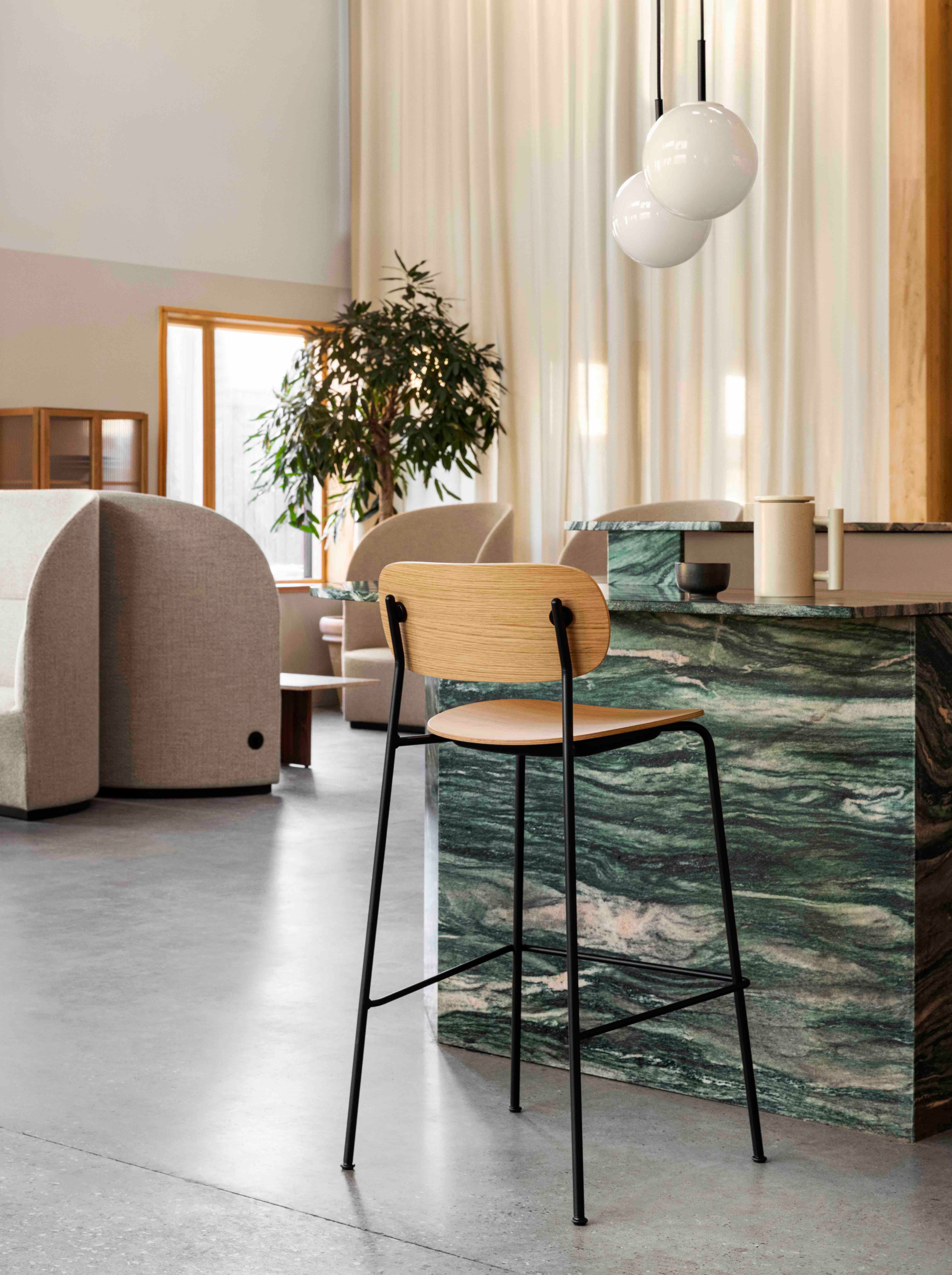 Cocooned shapes of the Tearoom collection offer privacy in public (above); while the Co Bar Chair offers an informal, yet comfortable perch for any occasion