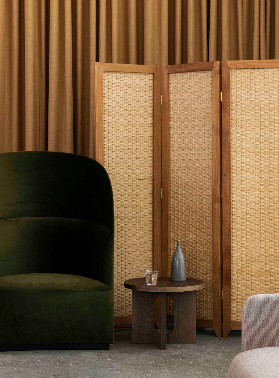 The Tearoom lounge chair with high back, pictured here with the Androgyne side table and the Strandgade stem vase
