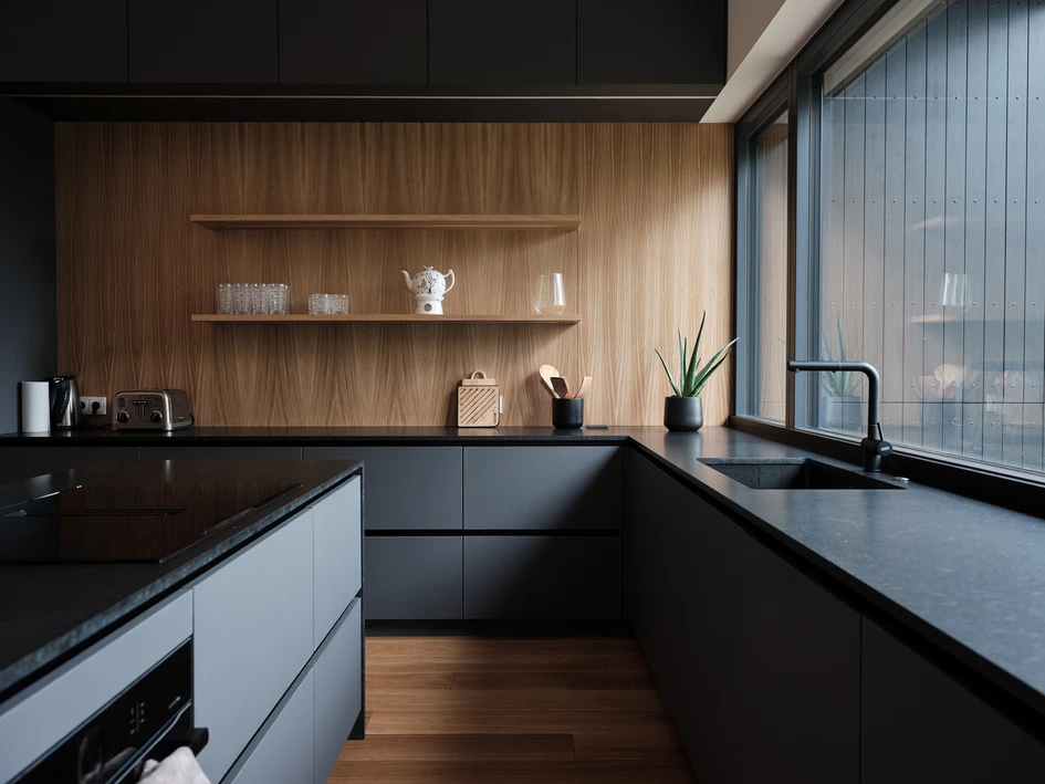 The House for a Family and Bikes is split across five separate levels, keeping the home visually and physically connected to the identifiable dark kitchen (bottom). Photos: Tõnu Tunnel
