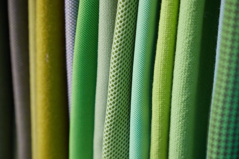 Top: examples of how light-giving elements can be woven together with textiles in cushions. Below: fabric panels in graduated shades of green with different textures. © Messe Frankfurt GmbH / Jean-Luc Valentin