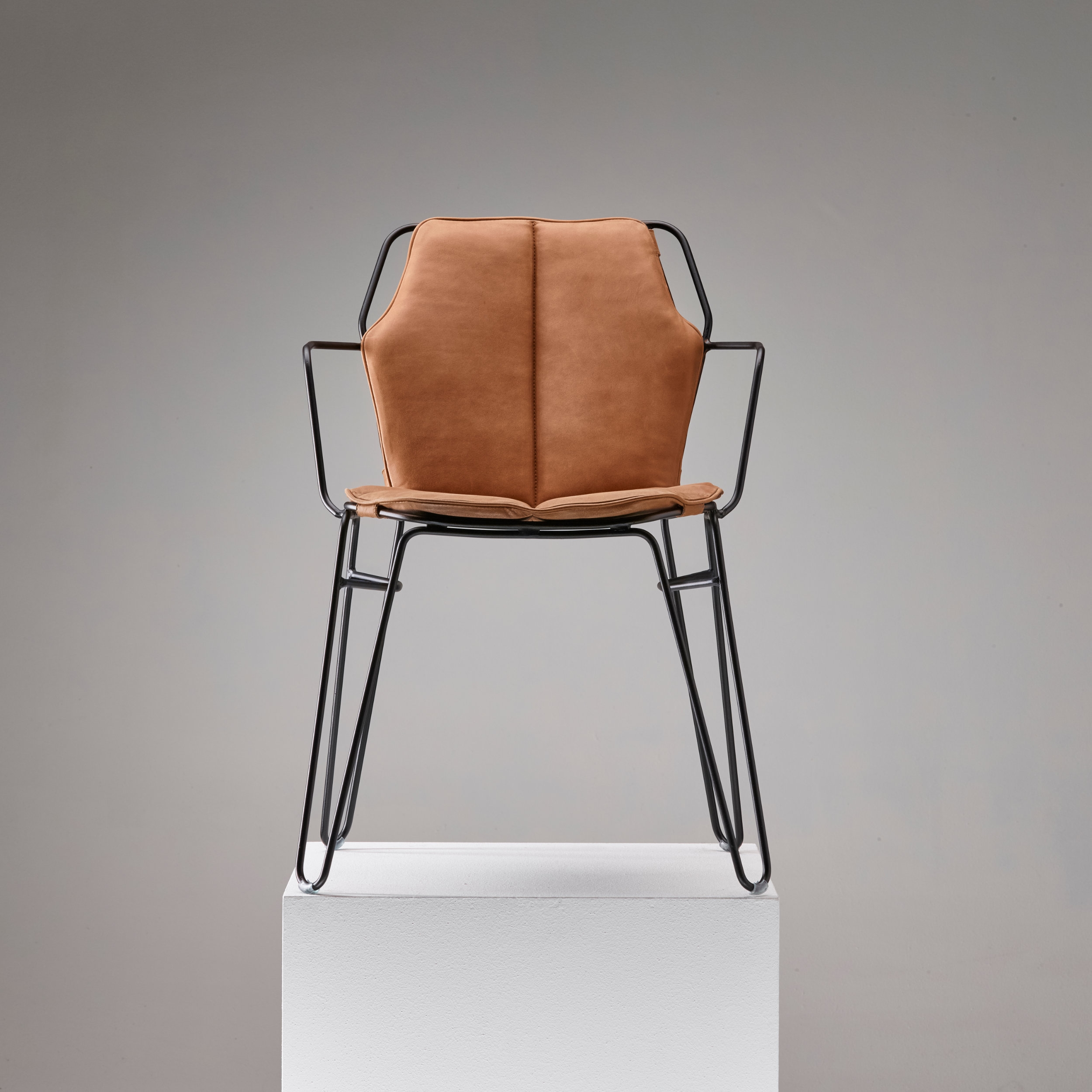 Stackable and suitable for outdoor use, the Ylfi chair collection designed by Jan Dijkstra is made entirely of steel and can be upholstered with a range of fabrics and leathers