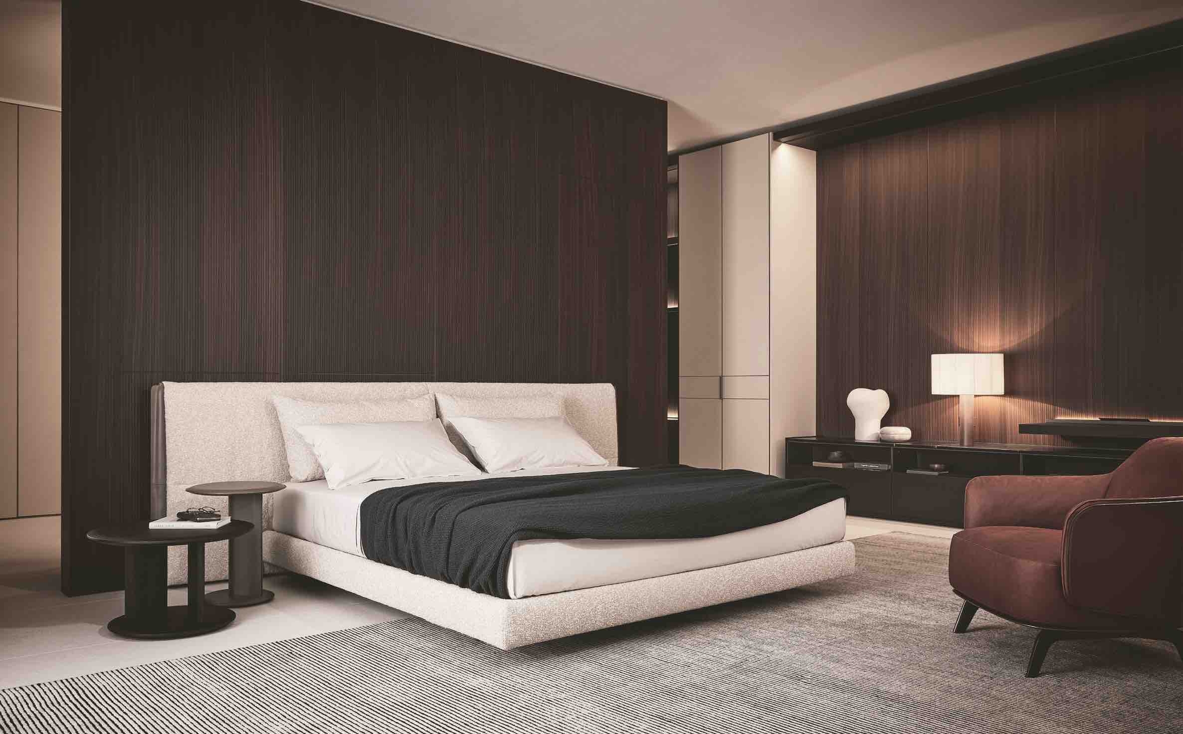 The upholstered Yume bed, designed by Massaud, is timeless, but material lightness and leather insert details inspired by the fashion world bring the piece firmly into the present