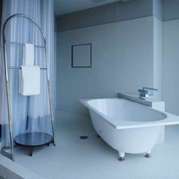 A slim frontage masked with translucent curtains (top) allows the Korinkyo Hotel’s interior to remain dimly lit, bathing the suites in a sensual intimacy of low natural light. Photo: Hiroki Kawata