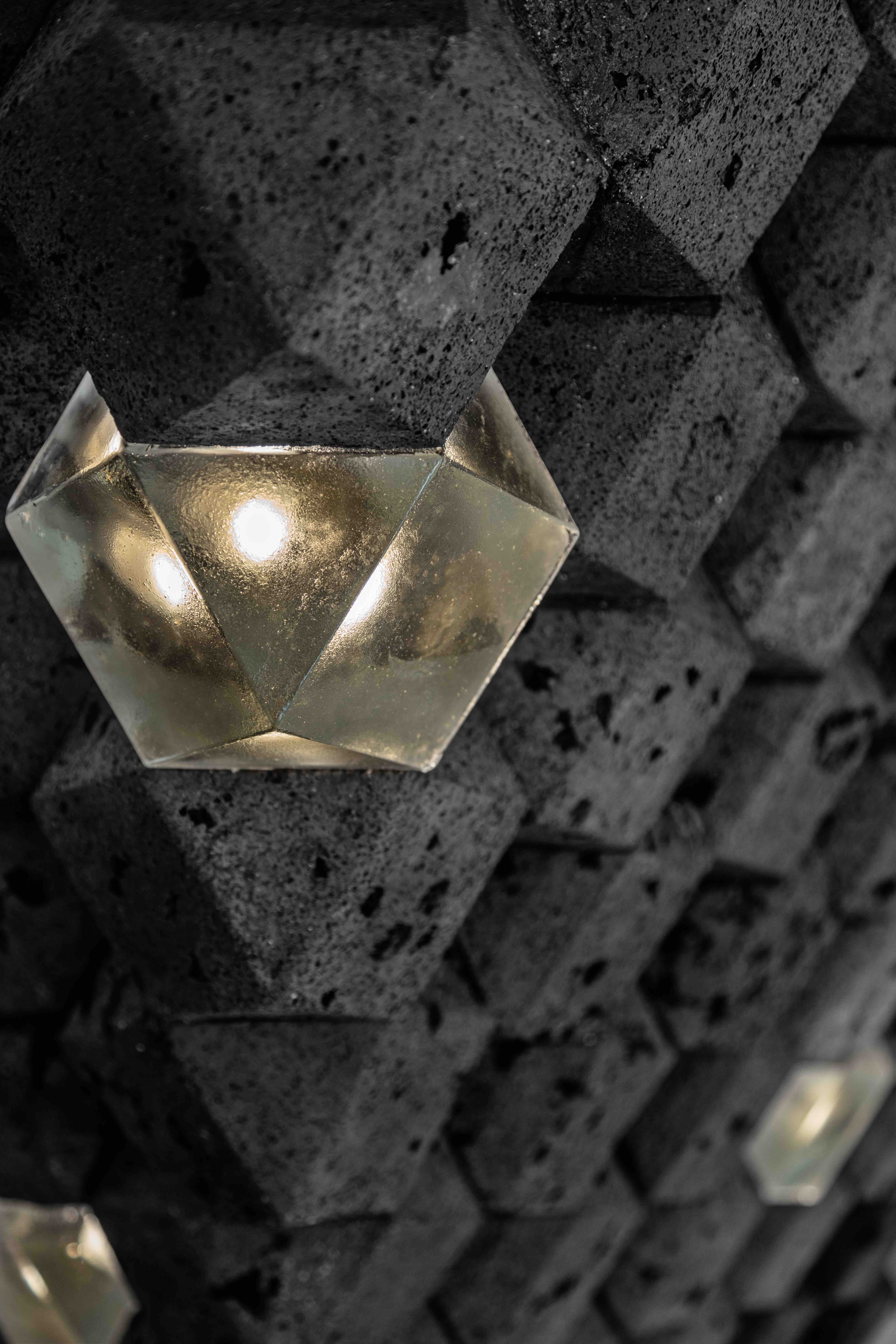 The reimagining of the Welles Chandelier by Dr Guan Lee features the signature cuboctahedrons in PoliRock, a material made by Lee’s team from waste and developed to resemble authentic rock