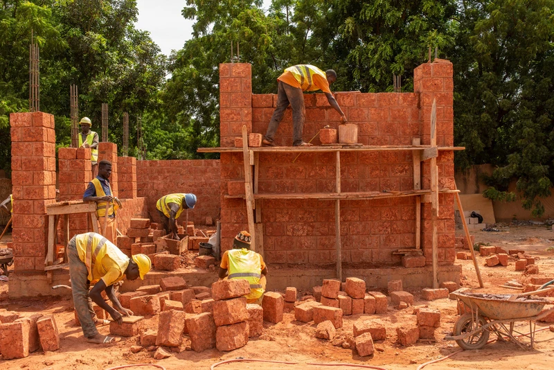 Article 25’s school with a passive roof design (top) teaches locals to work with hand-mined brick (middle) and laterite stone (bottom). Photos: Toby Pear (top, middle), Grant Smith (bottom)
