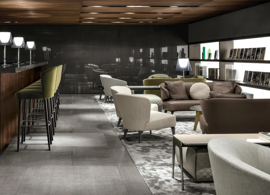 Although heavier and more difficult to move, bar stools with thicker upholstered backs like Minotti’s Aston stool support and envelop the whole lower back