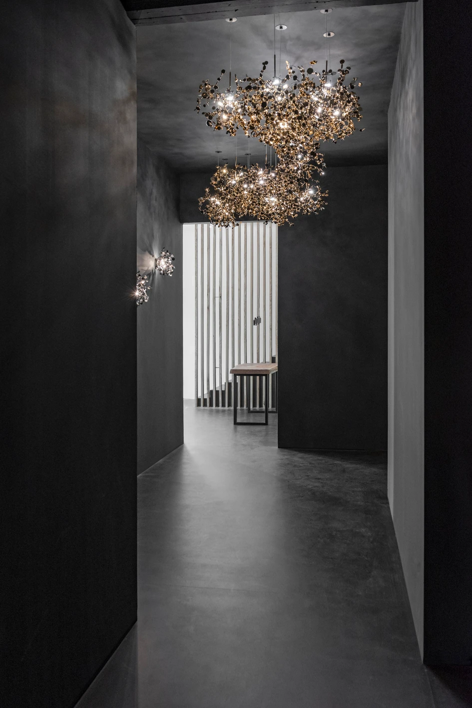 Terzani’s Florence showroom features dark-walled interior spaces that create an immersive environment for viewing its sculptural lighting products