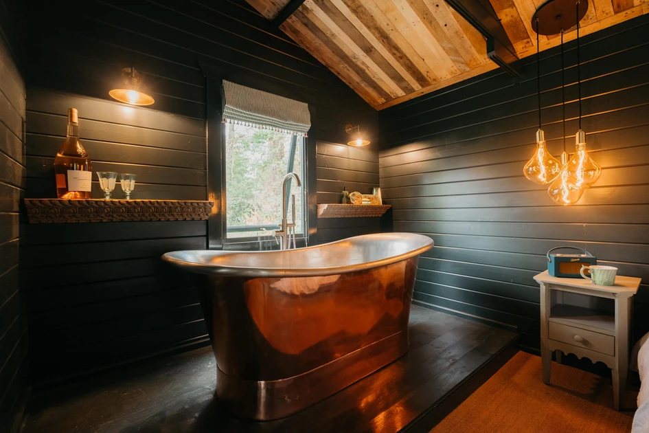 Stern Engineering’s Tubular 1000 tapware (top). Poltrana Frau’s Ren collection (middle). The Hide’s brass light fixtures and copper bath with timber background (bottom) Photo: Stuart Dudelston (bottom)
