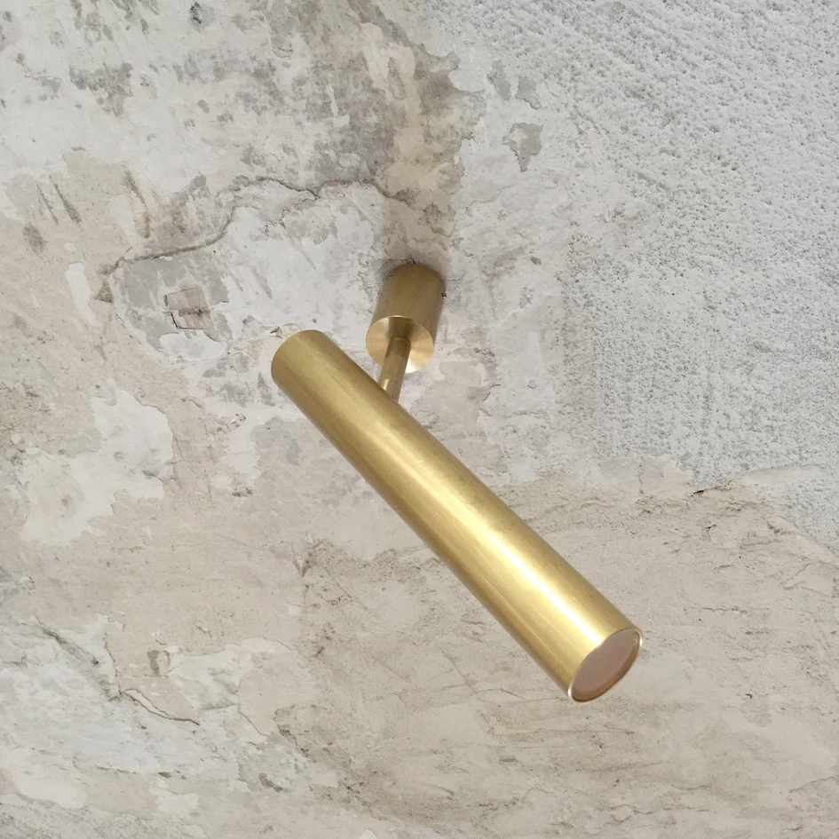 Brass lighting fixtures (top) and tapware (middle) combine in the 077 Residence in Prague, while Axolight’s Ego spot (bottom) offers a clean and simple brass accent. Photos: BoysPlayNice (top, middle)