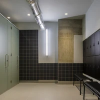 The kitchen area with exercise bike stools at TBWA/HOKUHODO (top) and Thomas House’s in-house boxing gym and showers (middle, bottom). Photos: Hakuhodo Product’s (top), Gareth Gardner (middle, bottom)