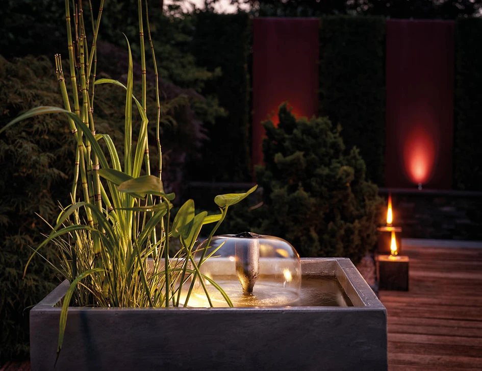 Wall-integrated waterfall kits from Oase install into existing walls (top), while smaller standalone fountains and waterfalls sit comfortably in concrete planters (bottom) on terraces and decks