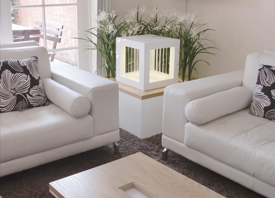 C+P Möbelsysteme’s workplace intended waterwall partition (top) purifies and humidifies its interior surroundings, while Oliver Kessler’s Rain3 cube (bottom) does the same in a 3D format