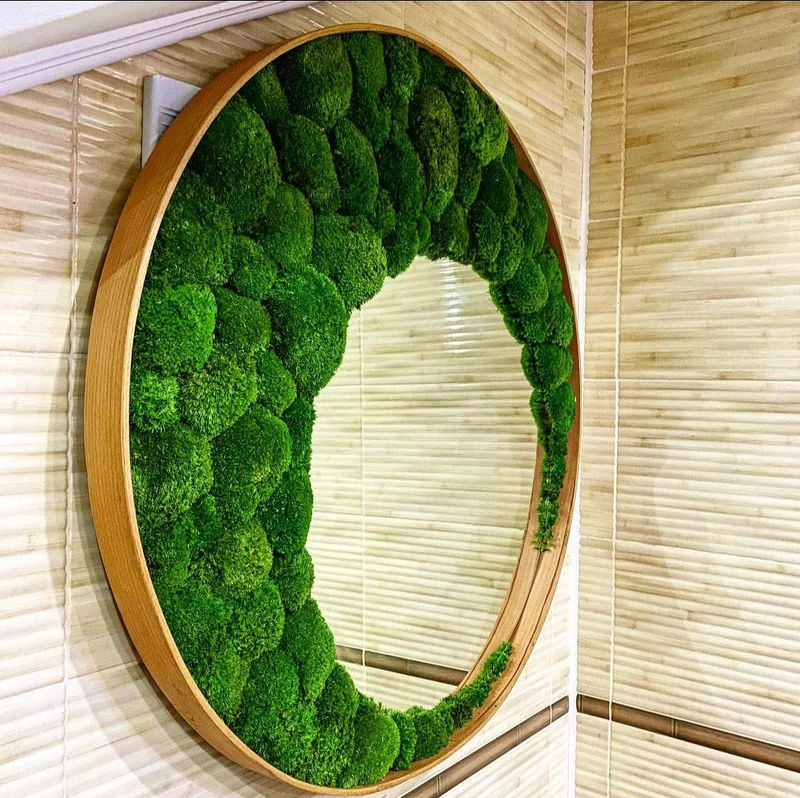 Moroso’s Ego Stud combines black steel and leather for a stylised look (top) and Ekomoss’ Mirror with Ball Moss adds softer textures with warm wood encircling a vertical miniature landscape (bottom)