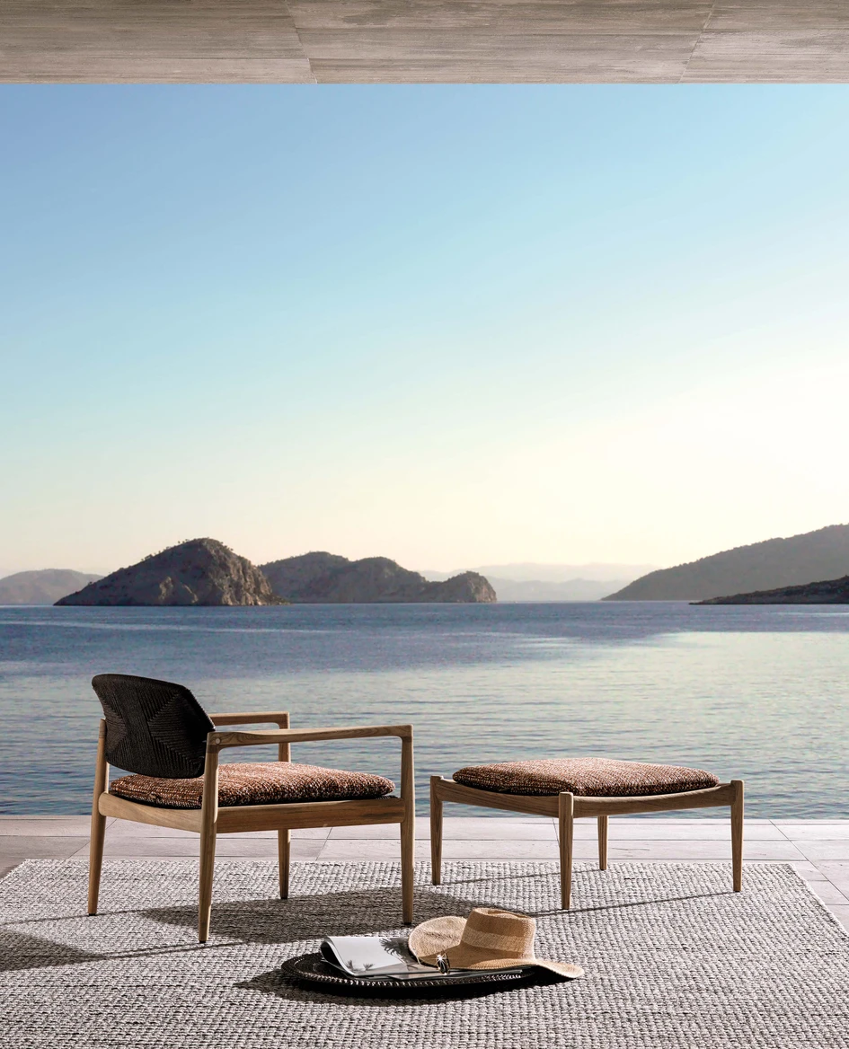 Elegant and ergonomic wood-working – seen here in the Lars sofa and Yoko Cord Outdoor armchair and ottoman bench