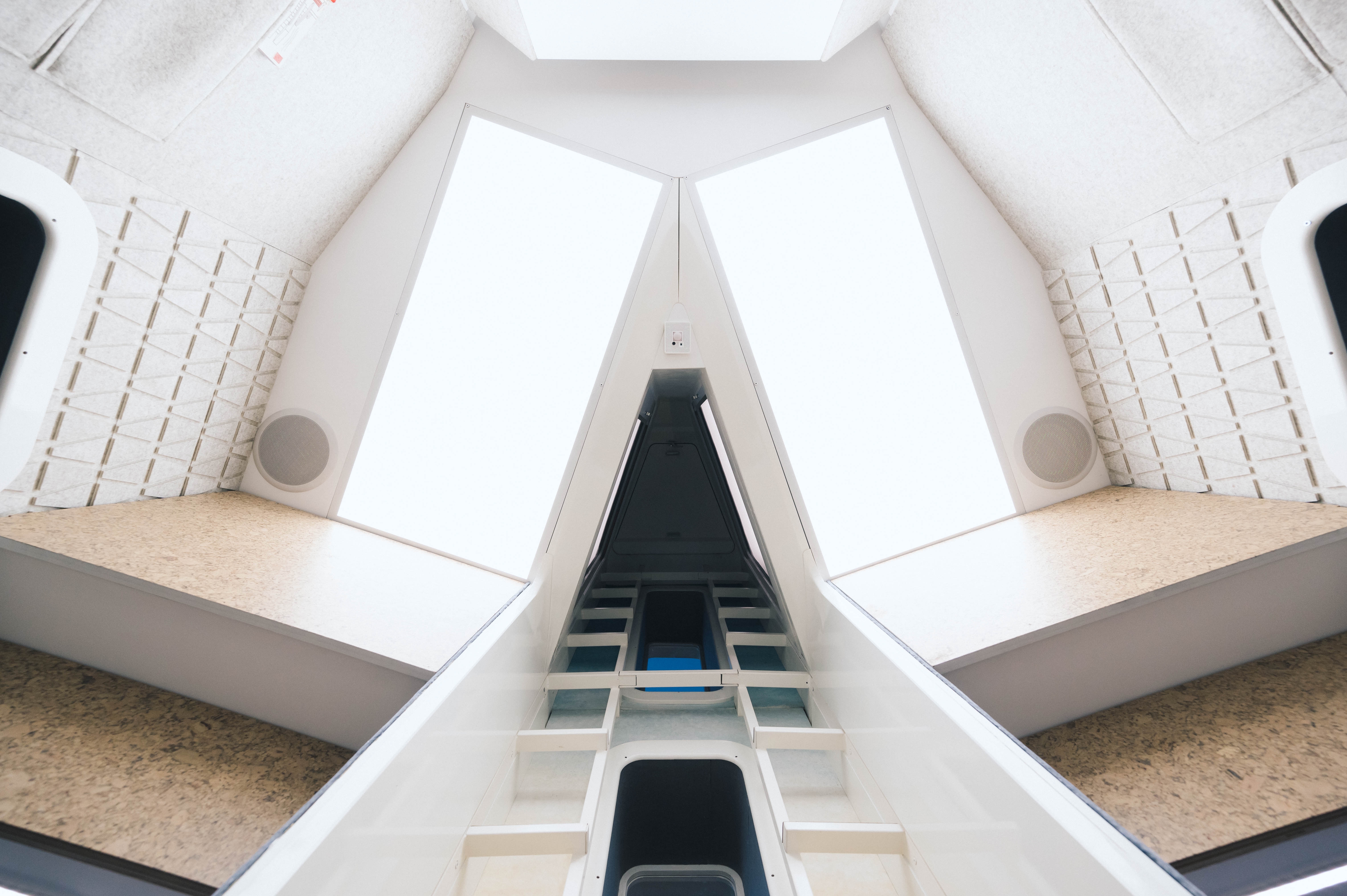 View from bottom to top: a brightly lit research platform on the middle level, with two sleeping chambers located higher up