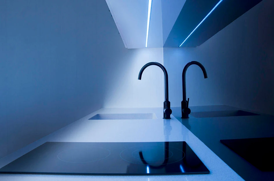 Recessed LED lighting strips like Light from Leicht Küchen AG (top) and Tribeca from Panzeri (bottom) bring functionality to sleek, minimalist kitchens