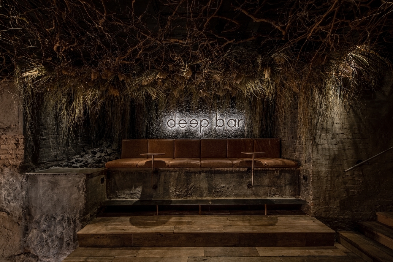 Hidden under a florist in Dnipro City, project architects YOD Group lines the Deep Bar’s ceilings with roots to symbolise its position and connection to the world above. Photos: Andriy Bezuglov