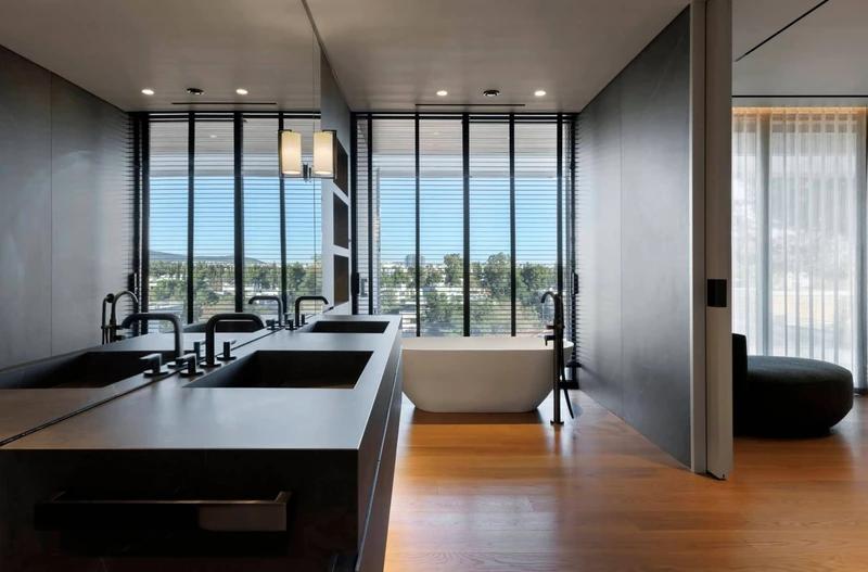The bathroom's jet-black features, chosen from Twelve Concept's extensive material catalogue, contrast with the generous natural light flowing into the space