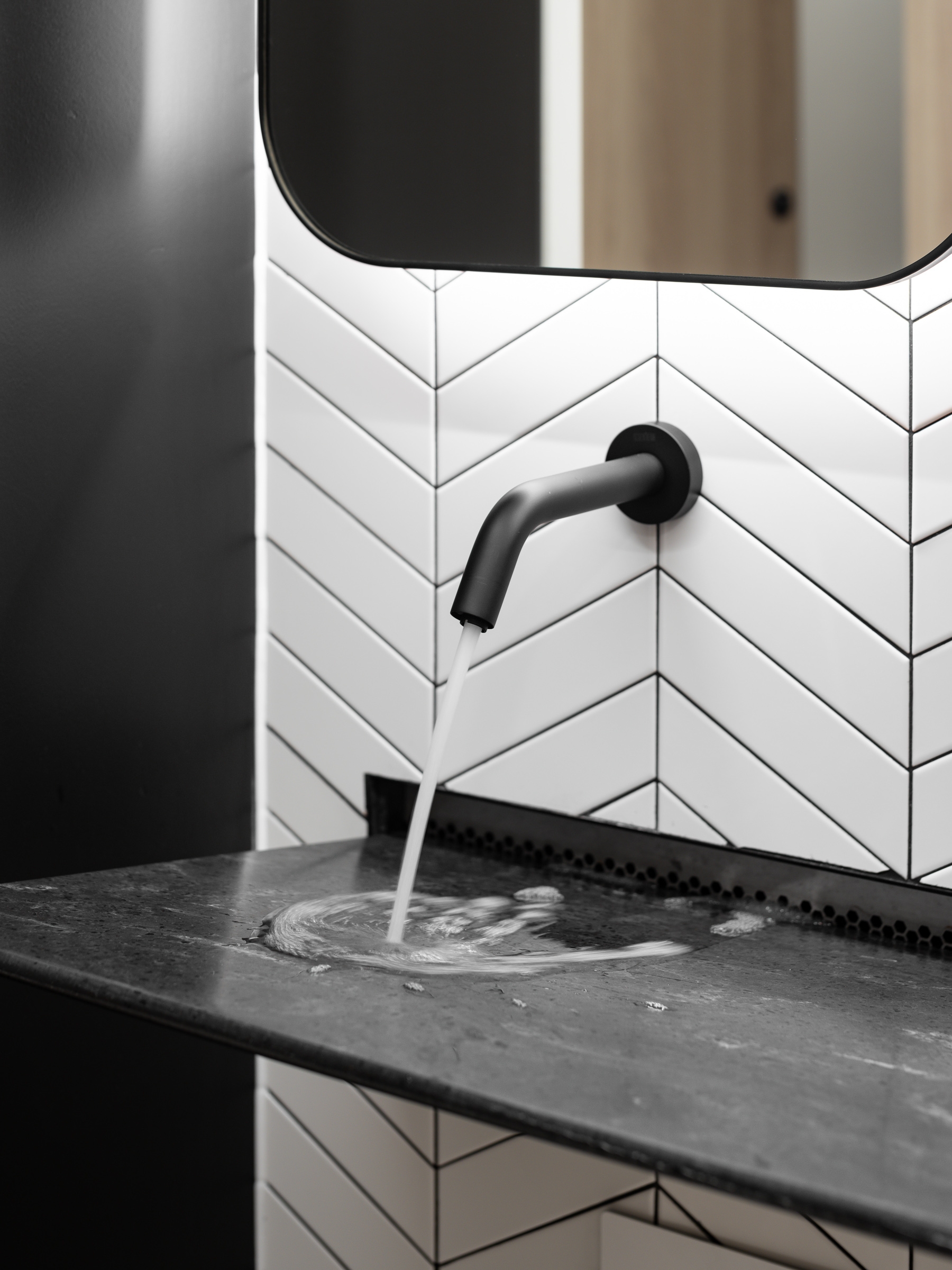 The Aerofoil basin in a black marble-like finish elevates the washroom of One Saint Paul’s Square, aligning the aesthetic goals set by architects GPAD in the lobby and common areas