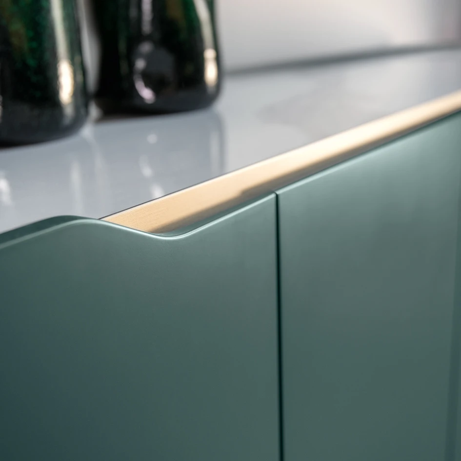 The sleek metal frame of the Oasi sideboard sweeps in fluid curves around the wooden body, hinting at motion within stillness