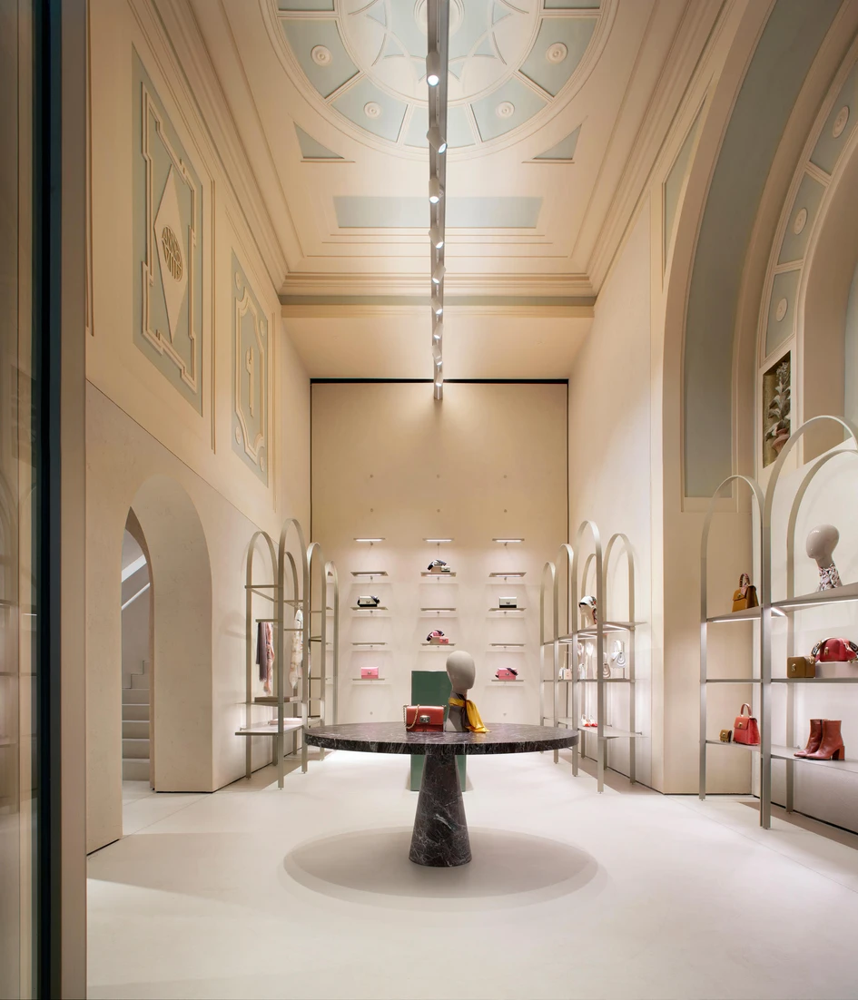 Light arched display shelving in the Furla Store Concept by David Chipperfield Architects allows the rough surfaces of the store to converse with the space. Photos: Alberto Parise