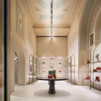Light arched display shelving in the Furla Store Concept by David Chipperfield Architects allows the rough surfaces of the store to converse with the space. Photos: Alberto Parise