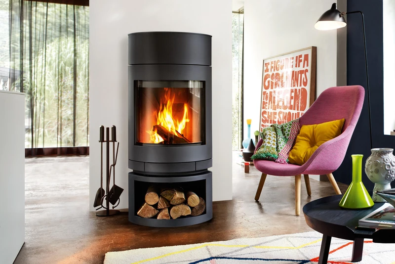 A corner fire spreads heat across this room in Norway (top), without interrupting the view, while turntable stoves like Emotions from Skantherm (bottom) direct it where it’s wanted. Photo: Kjetil Nordø