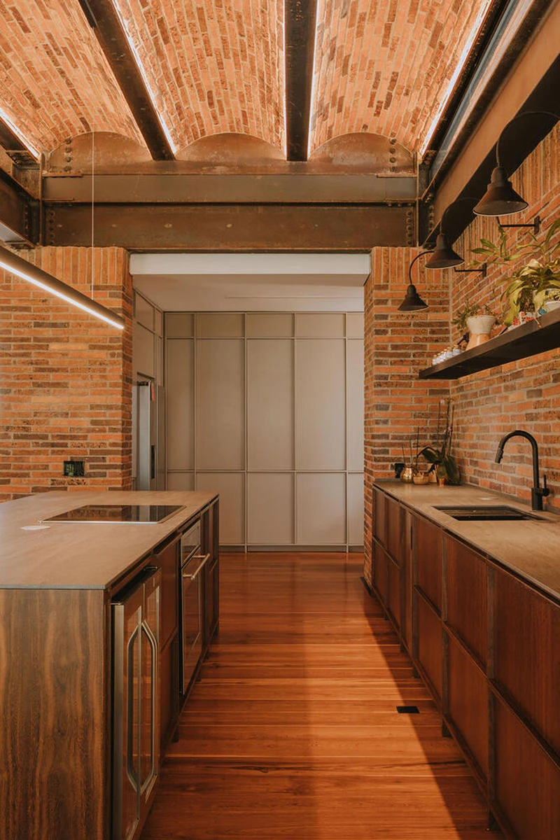 Raw and exposed yet warm and inviting. Brickwork brick walls bring cosy minimalism to this Colombian kitchen. Photo: Mateo Soto