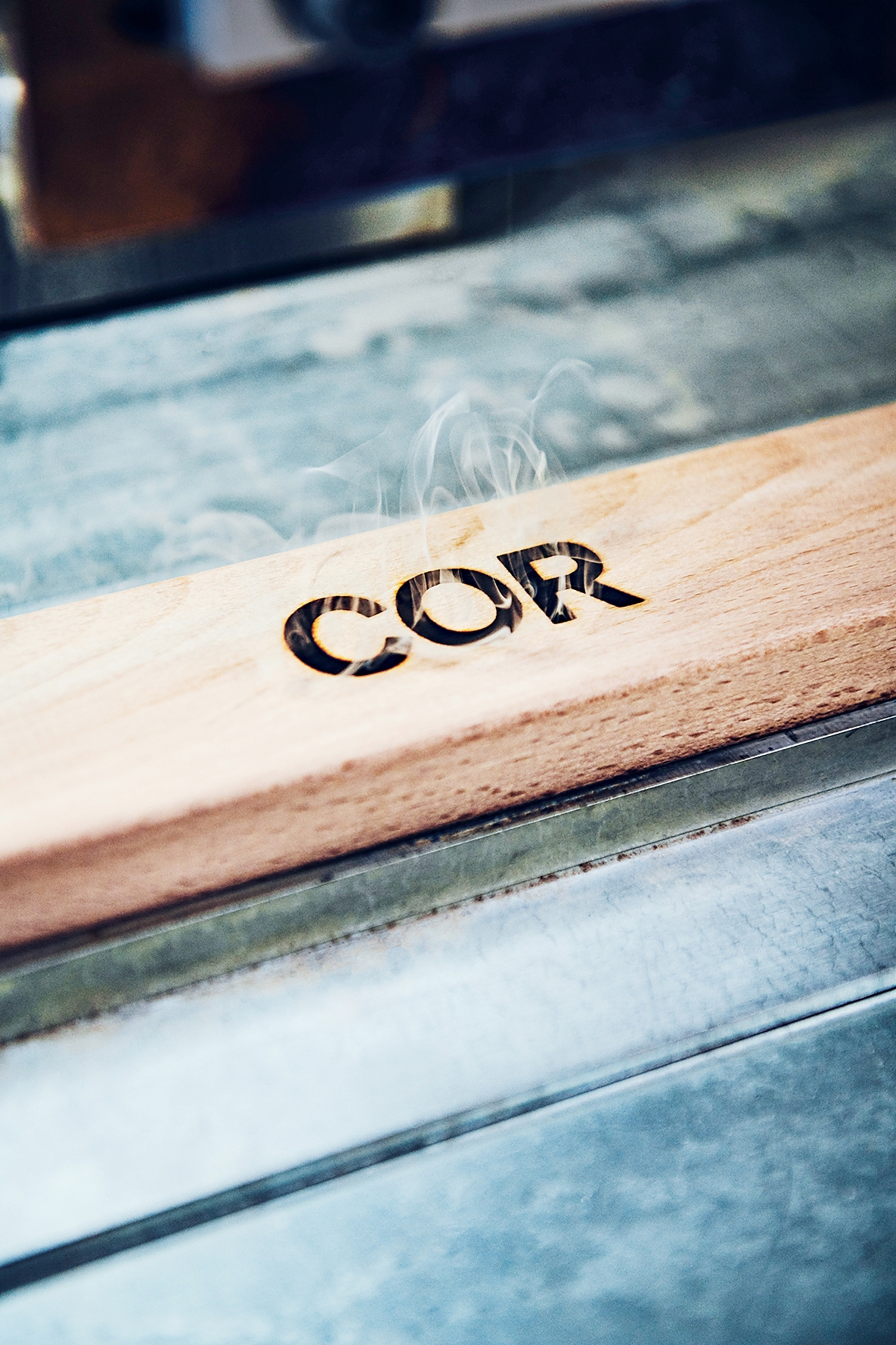 Leo Lübke is the CEO of the family company COR that was founded in 1954. Below: not a single frame leaves COR without a burnt-in logo – seen here on squared timber 