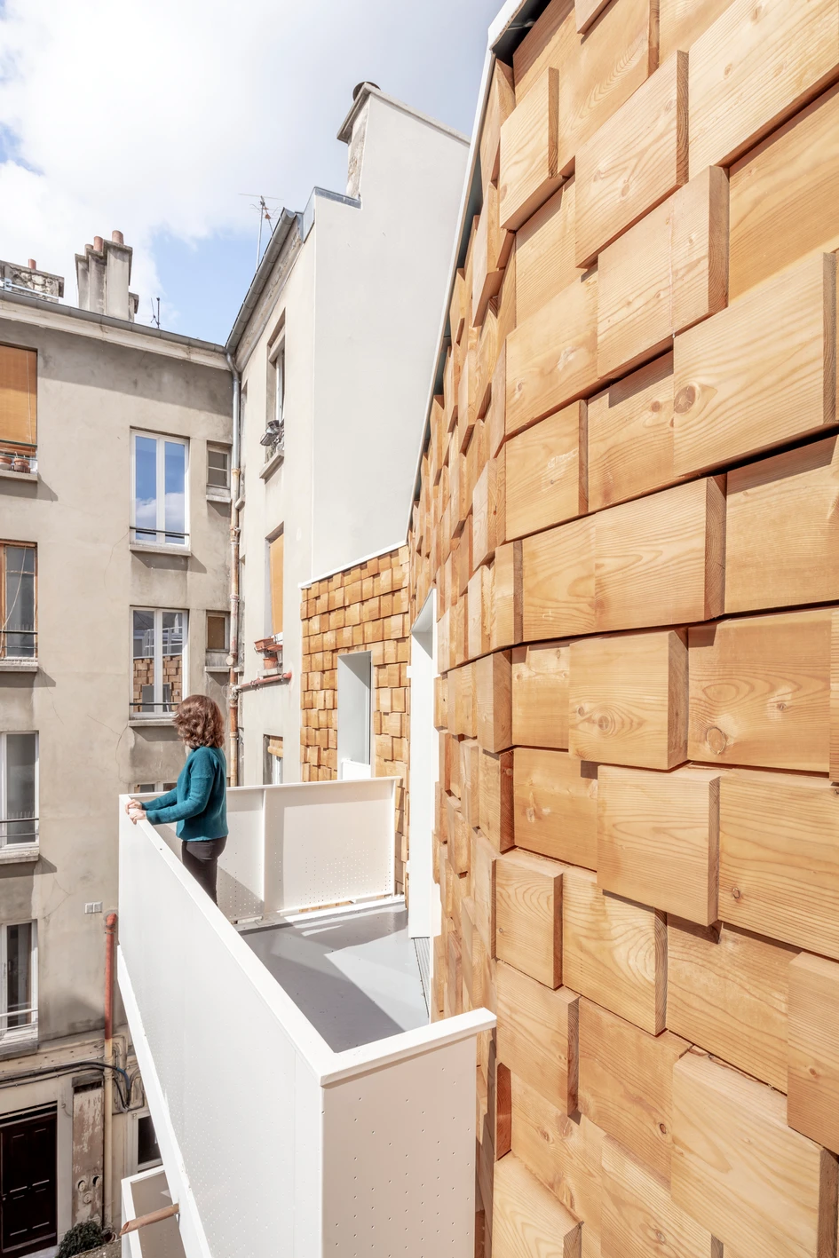Dropping a green courtyard in between the Street and Garden Apartments’ two buildings ensures each residence has both front and rear facades, flooding in natural light at both ends. Photo: Luc Boegly