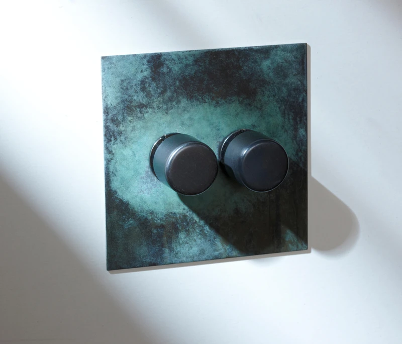 Buster + Punch's complementary metallic switch plates and door handles (top) with Forbes & Lomax’s sleek antique brushed bronze Rocker switch (middle) and oxidised Verdigris plate (bottom)