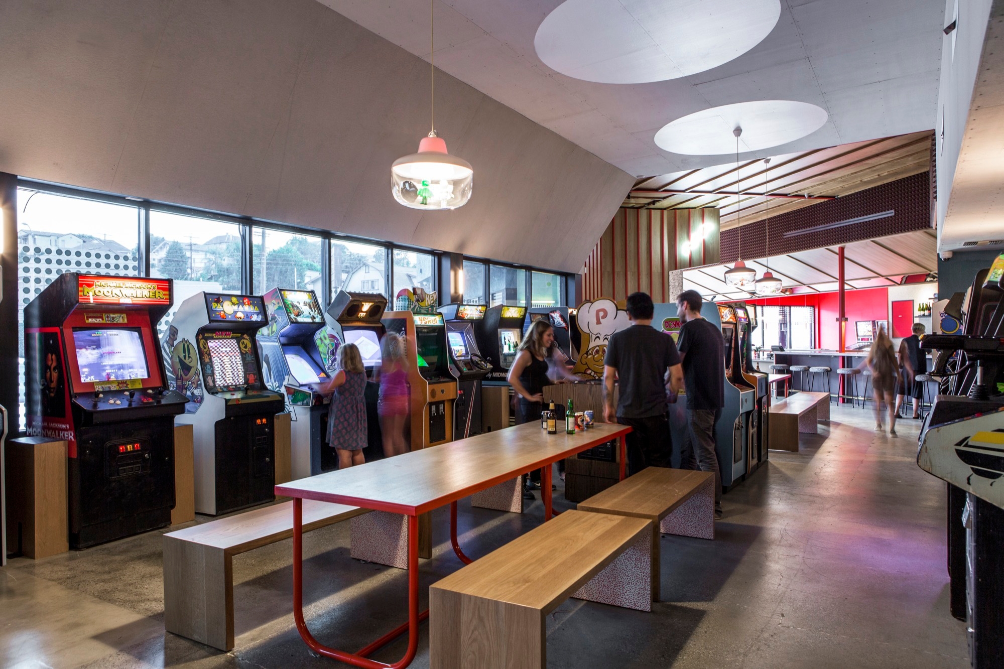 The arcade-game café takes a variety of material, colour and decorative references from 80s and 90s inspirations including two-tone upholstery (top) and custom wallpaper (middle). Photos: Laure Joliet
