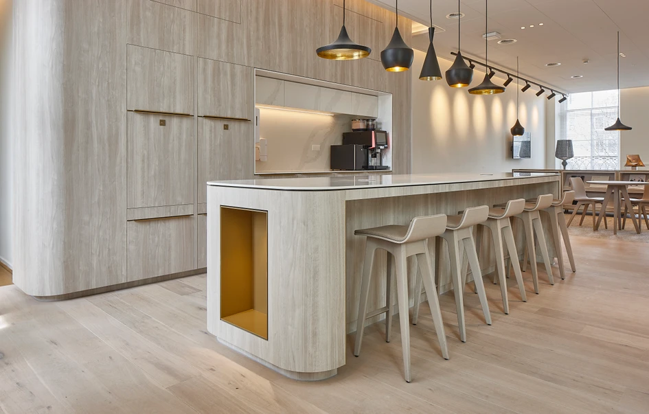 One of the characterful bar stools from the Zeitraum programme: upholstered Morph Bar stools in light wood finish at the bar of the Richemont in Amsterdam