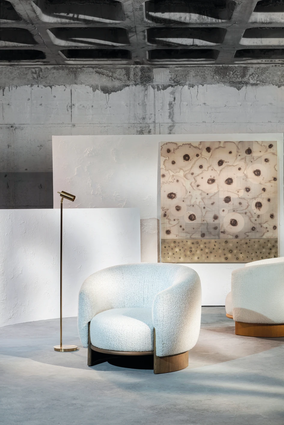 The Hug armchair utilises the same enveloping form as the Hug sofa, providing a soft and inviting seat covered with tactile bouclé upholstery