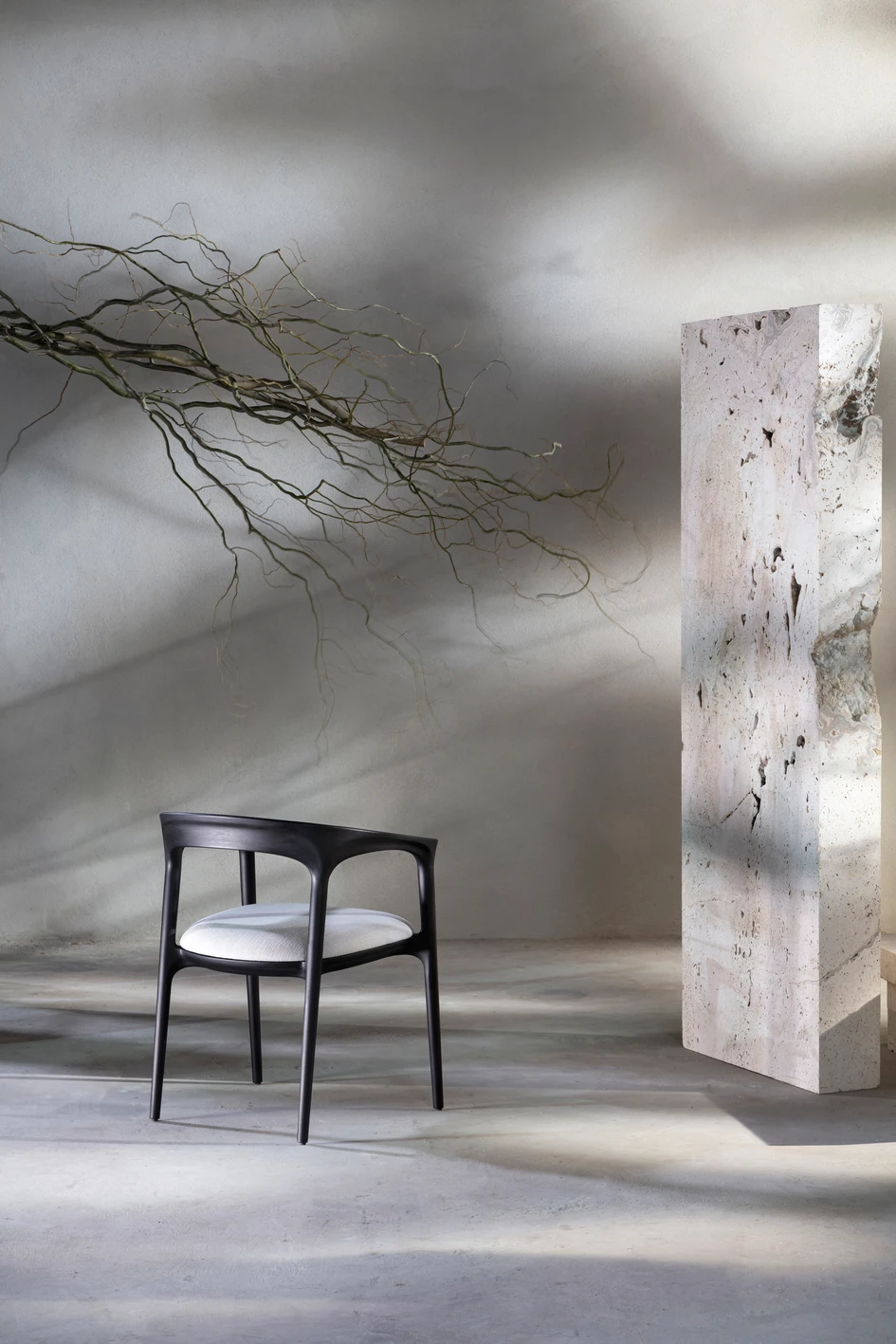 The Fau A armchair features a light but stable structure crafted from solid wood and a comfortable seat upholstered in premium fabric