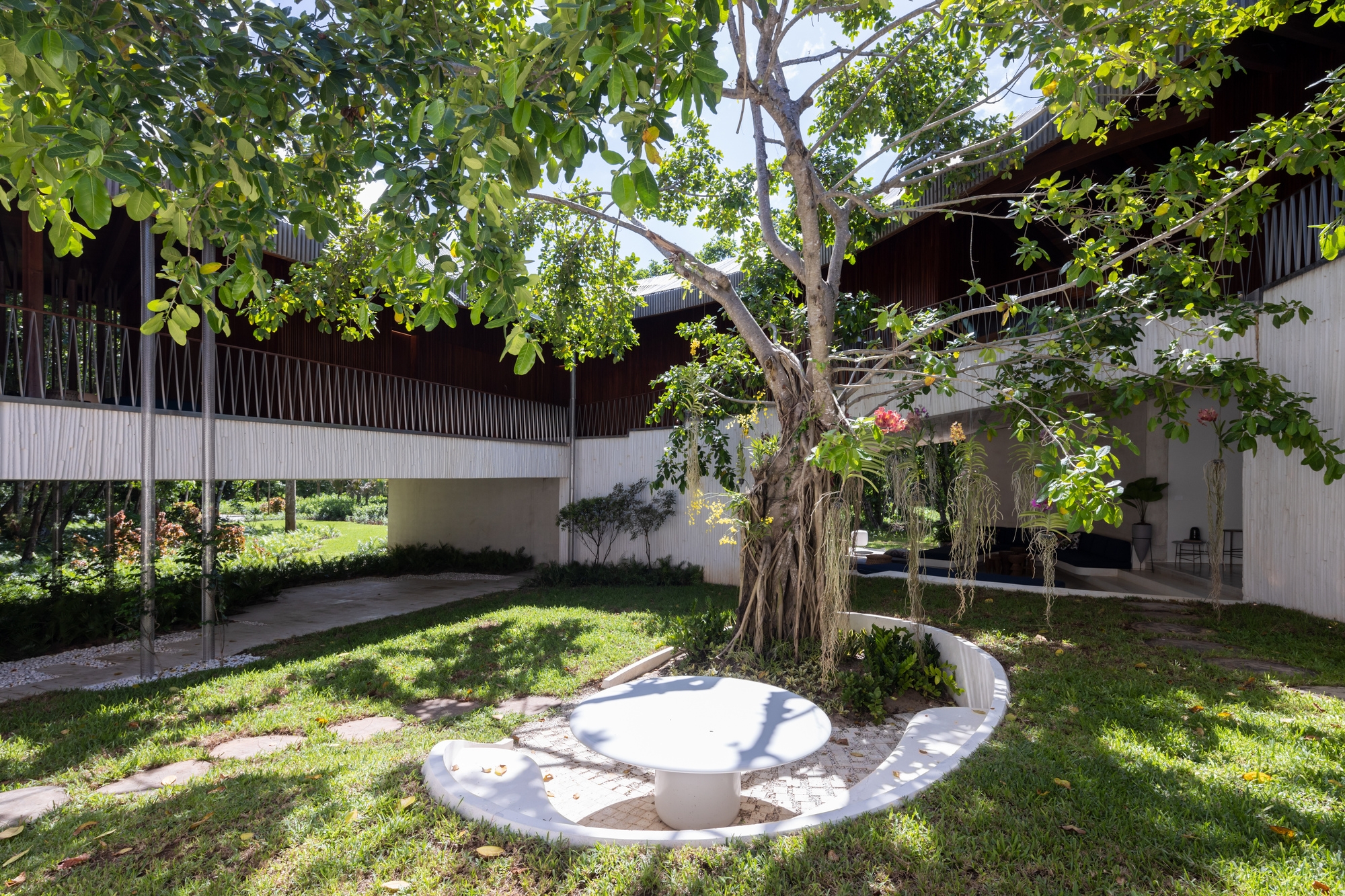 Two more of the East End House’s assorted dining spaces (top, middle) and the dappled light kissing Casa Las Olas’ outdoor seating (bottom). Photos: Albert Vecerka/Esto (top, middle), Iwan Baan (bottom)