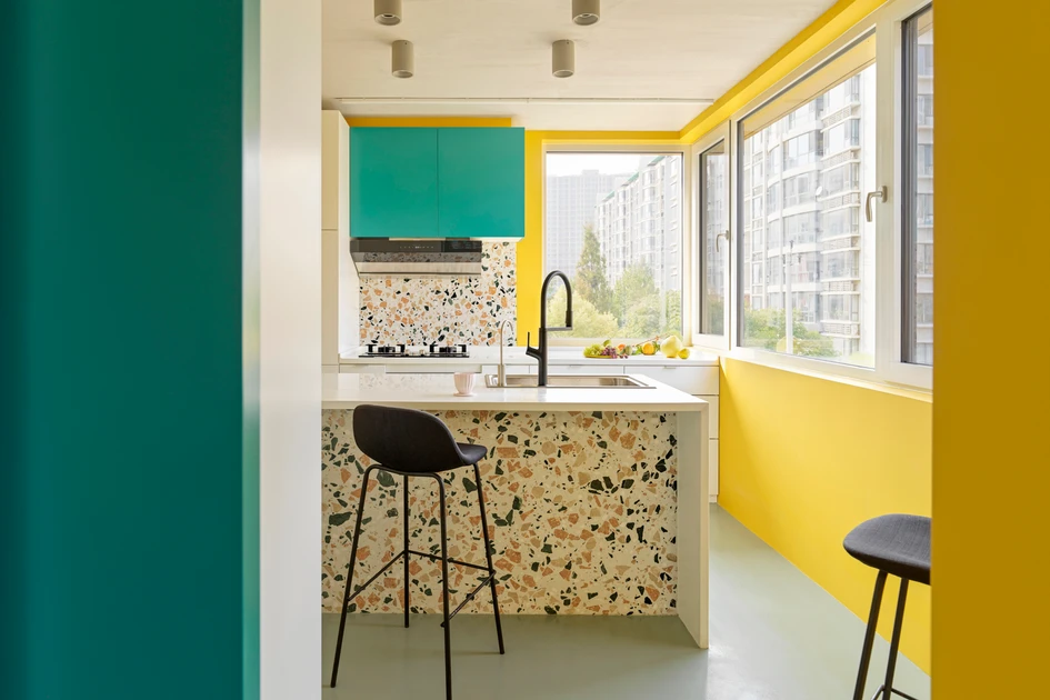 Terrazzo floors and surfaces feature highlights of gold and blue that bring out the bold yellow and turquoise in the colour-blocked interior and accents of House P. Photo: Jonathan Leijonhufvud