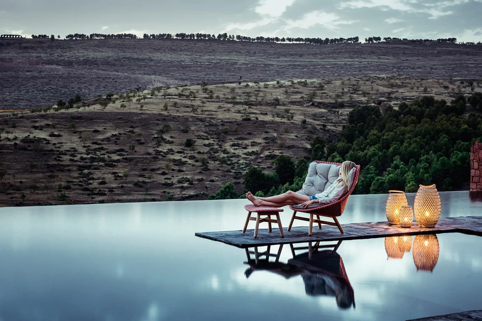 Sebastian Herkner’s outdoor MBRACE seating collection for DEDON uses traditional weaving techniques to keep its solid, weatherproof frame and seat light and moveable