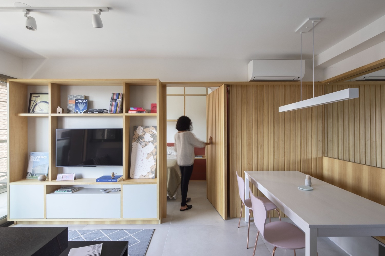 Linear wood panelling at the Ortho Apartment by Fabrica Arquitetos allowed the architects to hide a secret door. Photo: Pedro Napolitano