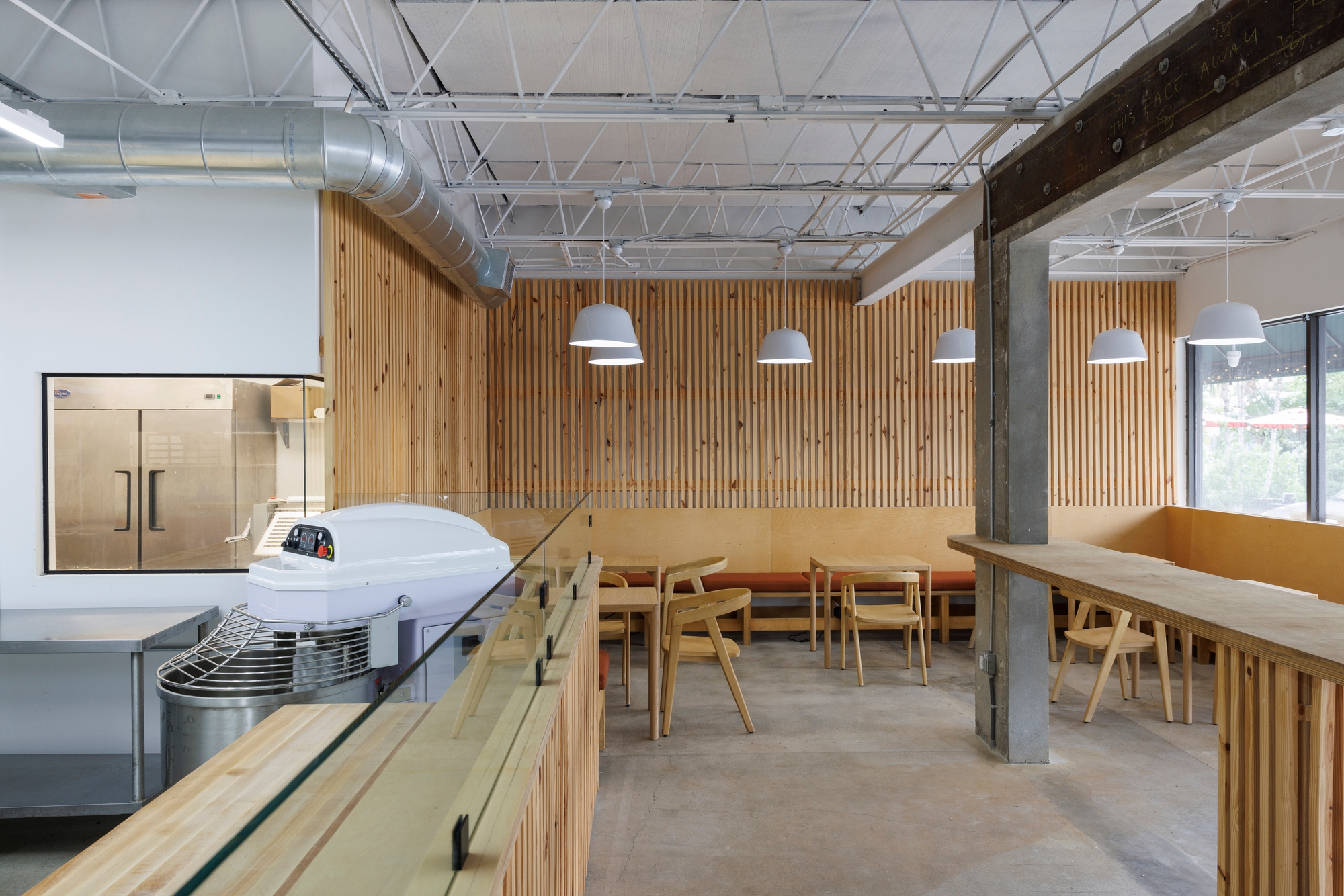 The bar-height counter in the centre of the Caracas Bakery allows customers to watch the bakers amongst the scent of fresh-baked bread. Photo: James Jackman