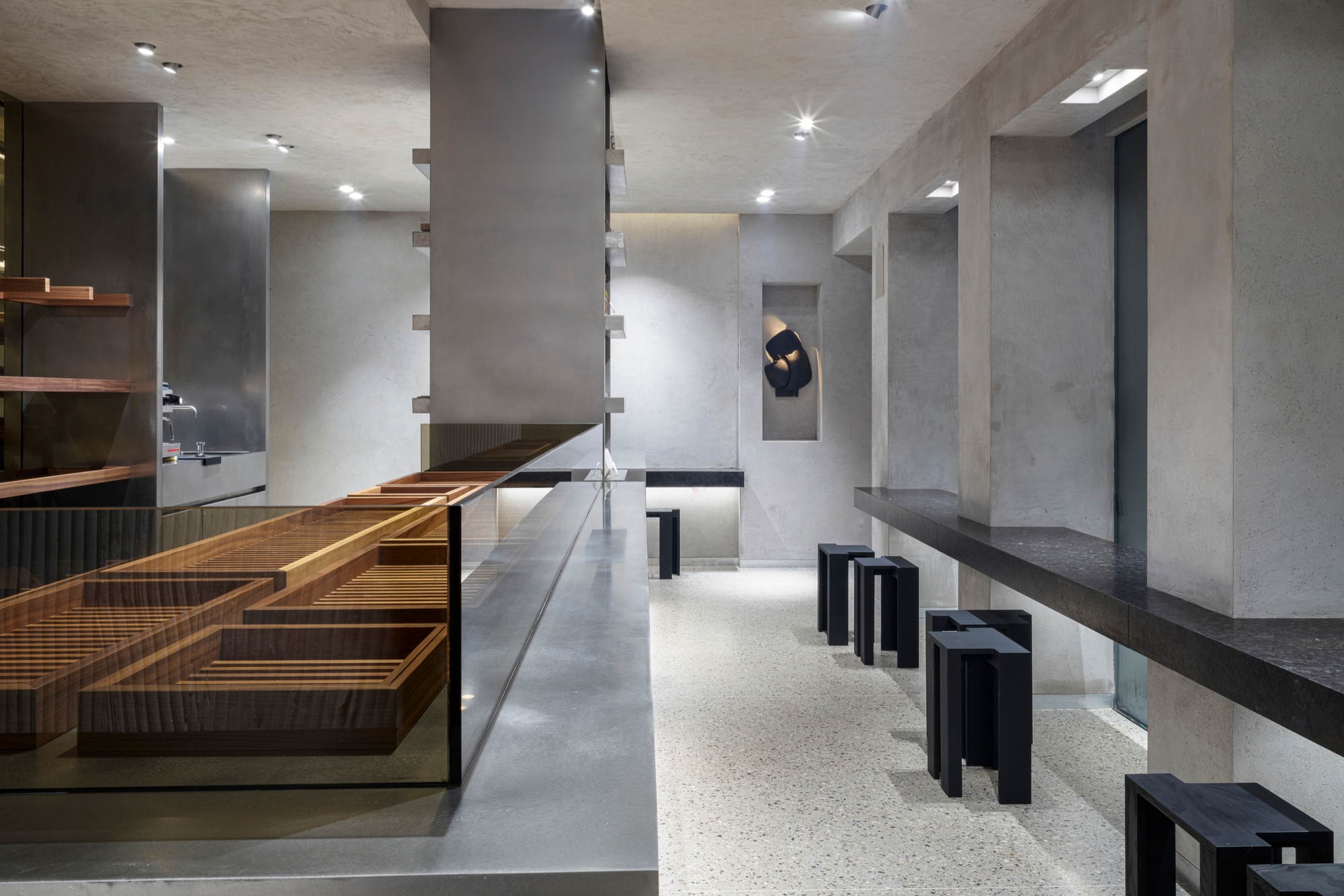 Open-backed shelving at The Bakery allows customers to peek through at the kitchen behind, while an austere decor of stainless steel ensures the loaves’ golden crusts star. Photos: Jean-Pierre Gabriel