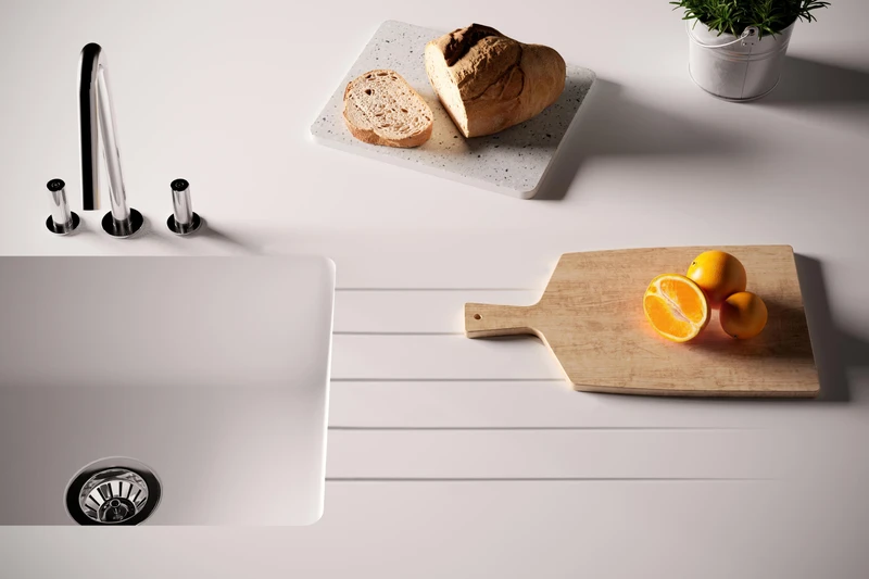 Schock’s Signus sink (top) uses a patented overflow to protect the bowl from wastewater while drainage grooves can alternatively be routed straight into solid-surface worktops like HIMACS (bottom)