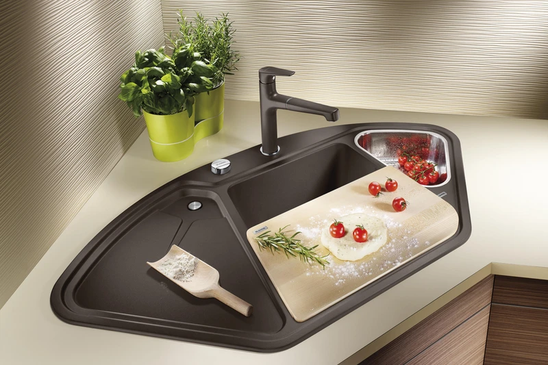 Corner sinks like Blanco’s Blancodelta fit snugly into the kitchen counter corner, making good use of this awkward area