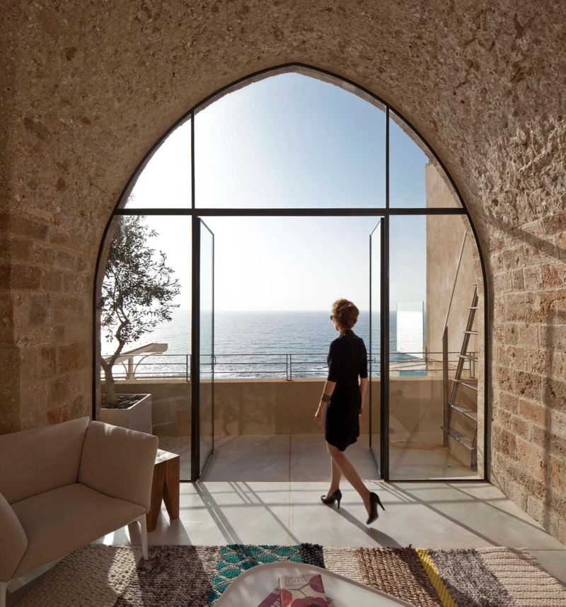 The arches and fitted archway balcony doors at The Arches housing project (top, middle) and Jaffa Apartment’s pointed archway window (bottom). Photos: AVR London (top, middle), Amit Heron (bottom)