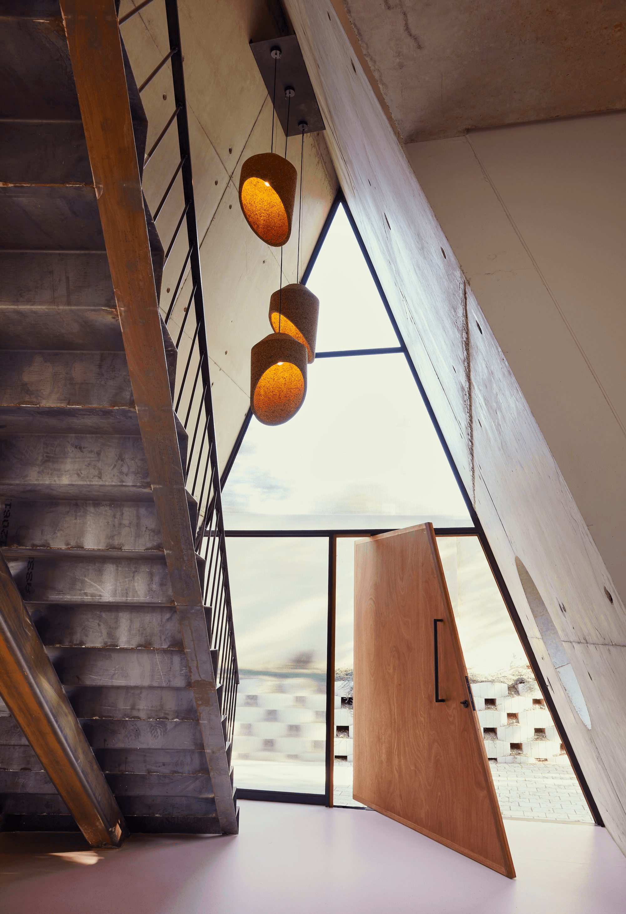 Triangular windows at the House of Triangles (top), and semi-circle and triangle windows at the Great Primary Shapes House (middle, bottom). Photos: Thiet Vu (top), Elsa Young (middle, bottom)