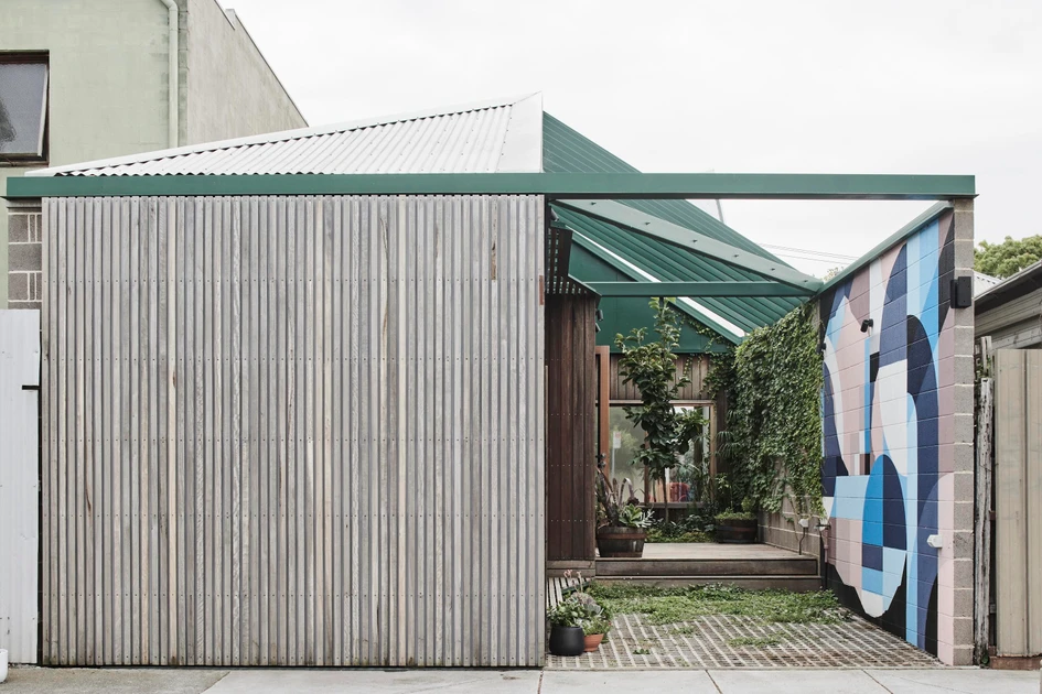 FIGR Architecture & Design studio designed the bathroom at Hot Top Peak House in Richmond, Australia (top), in a bold mix of primary colours and with playful art accessories. The entryway (bottom) adds another element of creativity. Photos: Tom Blachford