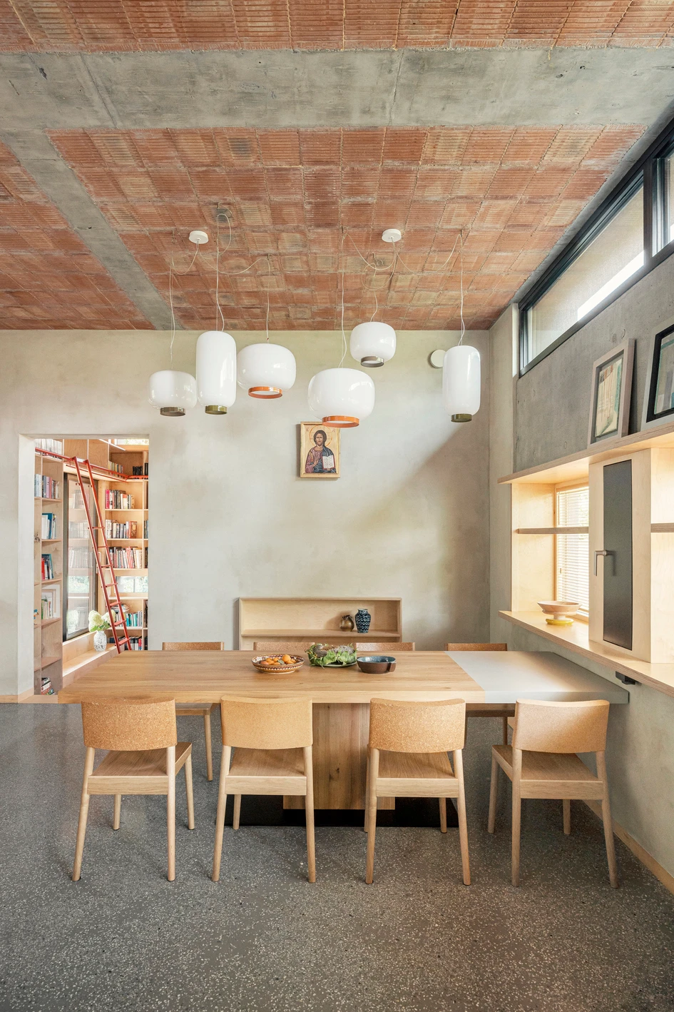 With a lowered floor, the home’s reading room has a little extra height. Even the shelves at the very top are easily accessed with the moveable ladder. Photos: Kroniki.studio