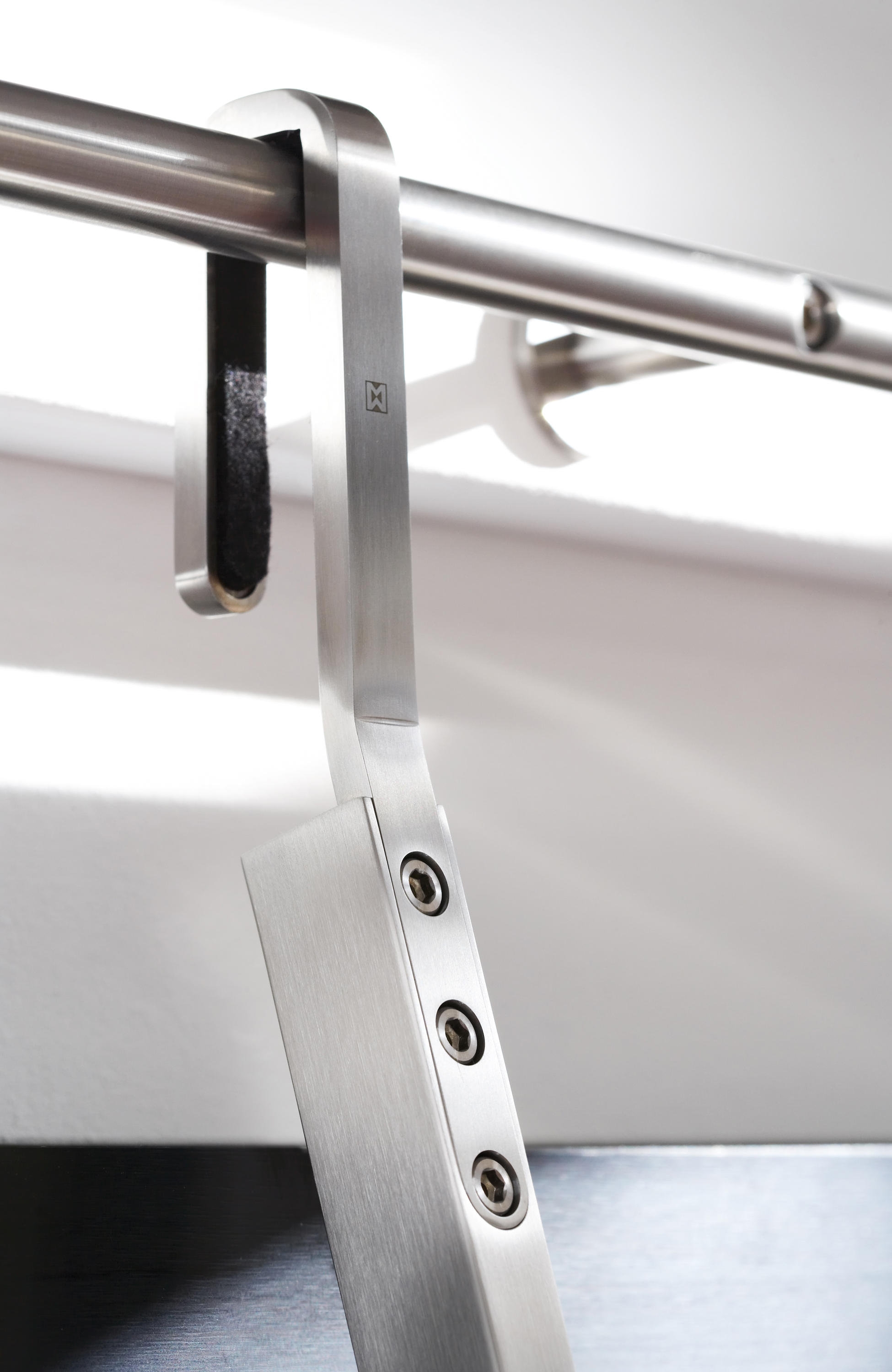 The Hook system from MWE can simply be pushed back towards the wall or shelving, to take up less space when out of use